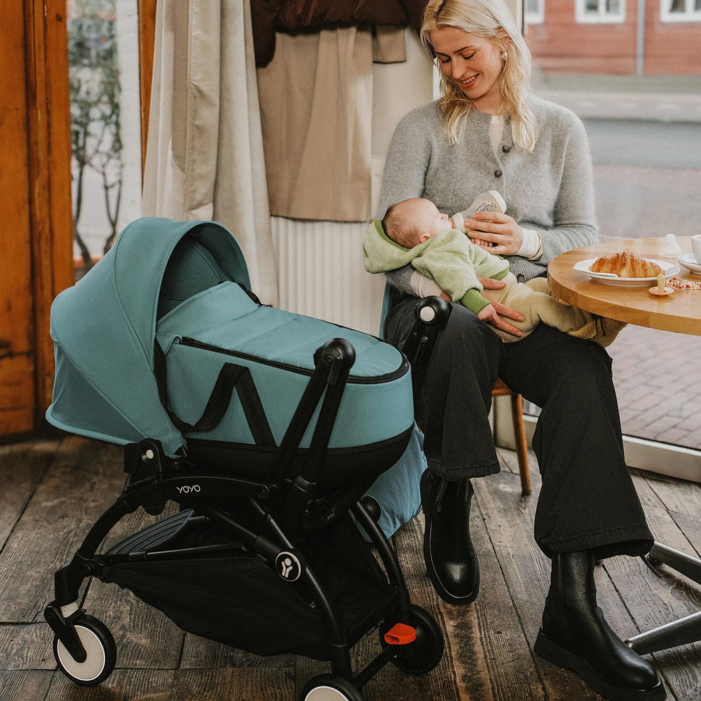 A parent with their newborn beside a Stokke YOYO pram — official Stokke retailer in Singapore