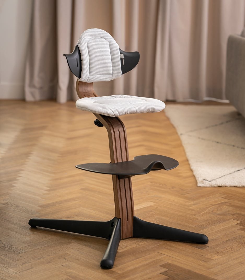 The Stokke Nomi Cushion on a Nomi chair at the table