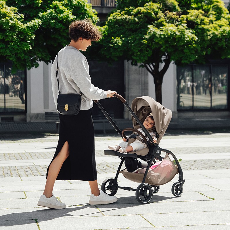 Mother strolling through the city with the Britax Rio stroller